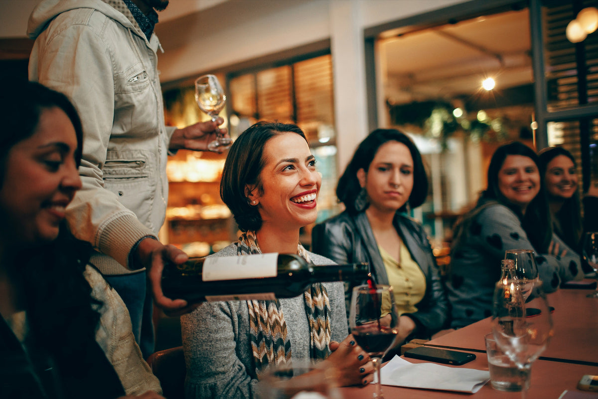 Friends toasting around a table